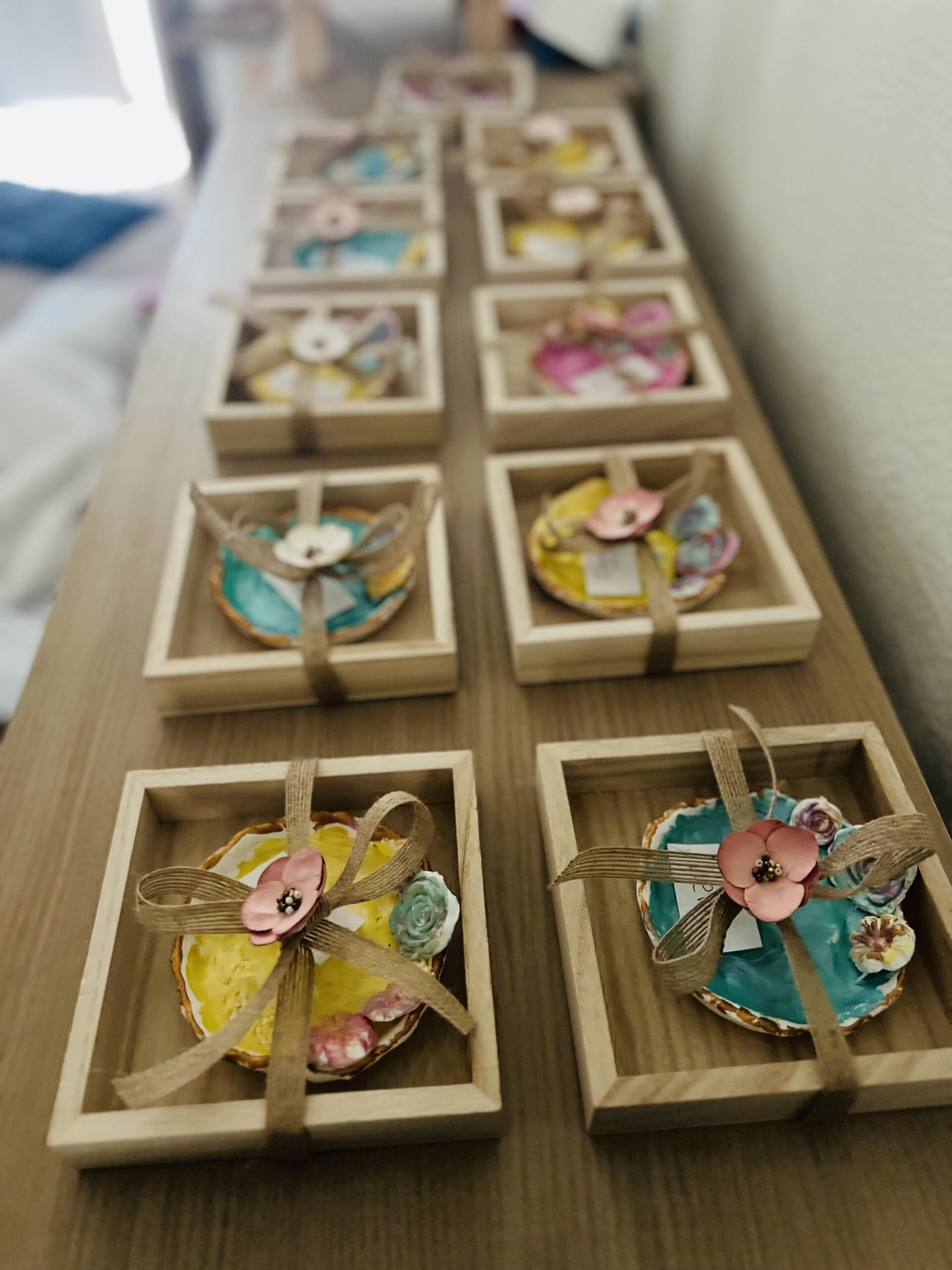 Small wooden boxes adorned with colorful paper flowers, used in a Montessori Education Daycare setting.